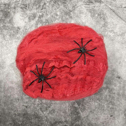 a red hat with black spider webs on it