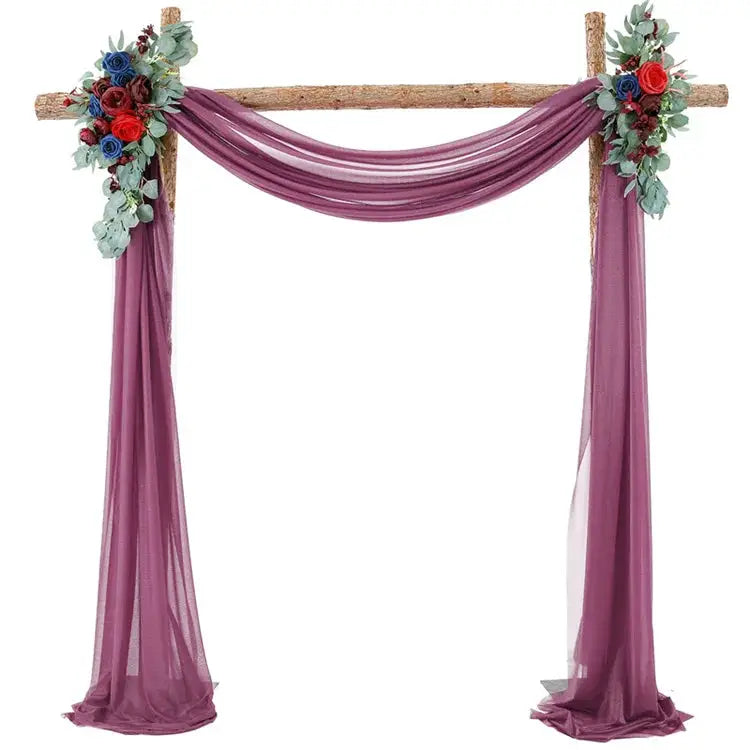 a purple wedding arch decorated with flowers
