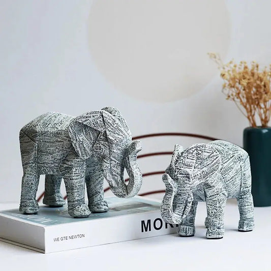 a couple of elephants standing on top of a book