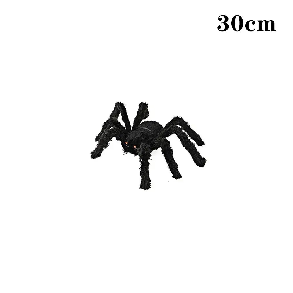 a large black spider sitting on top of a white wall