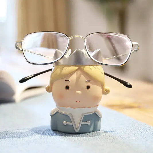 a small toy with glasses on top of it