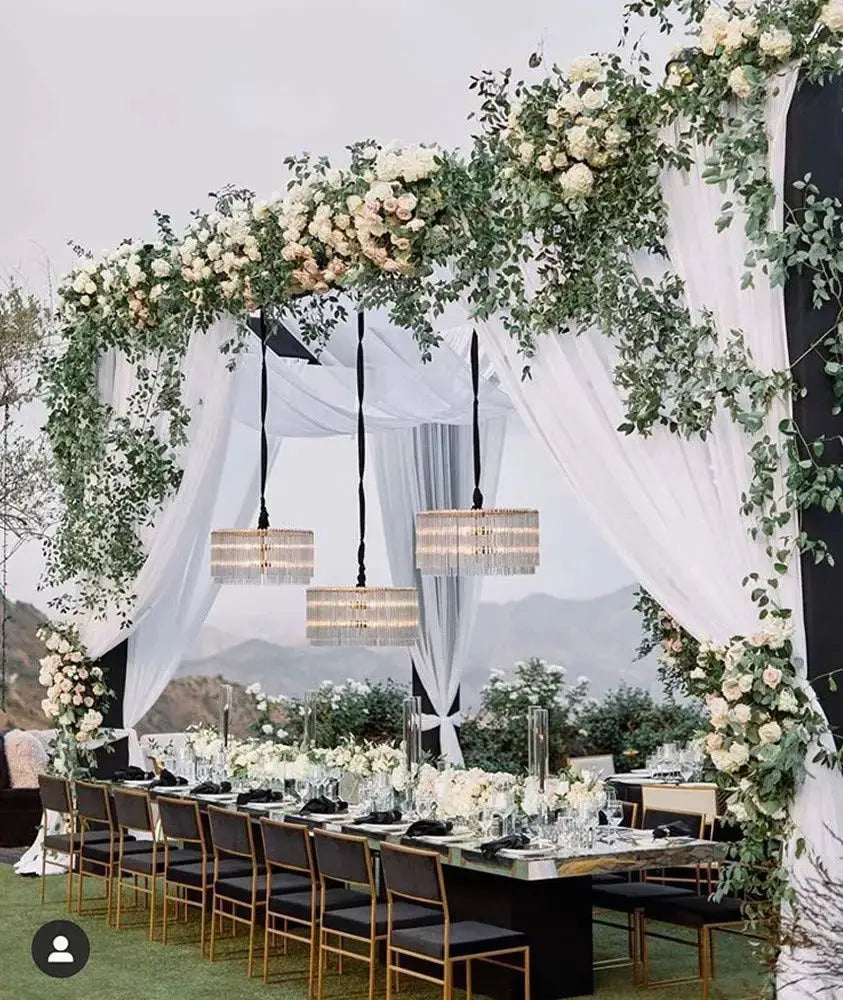 a long table with white flowers and greenery on it