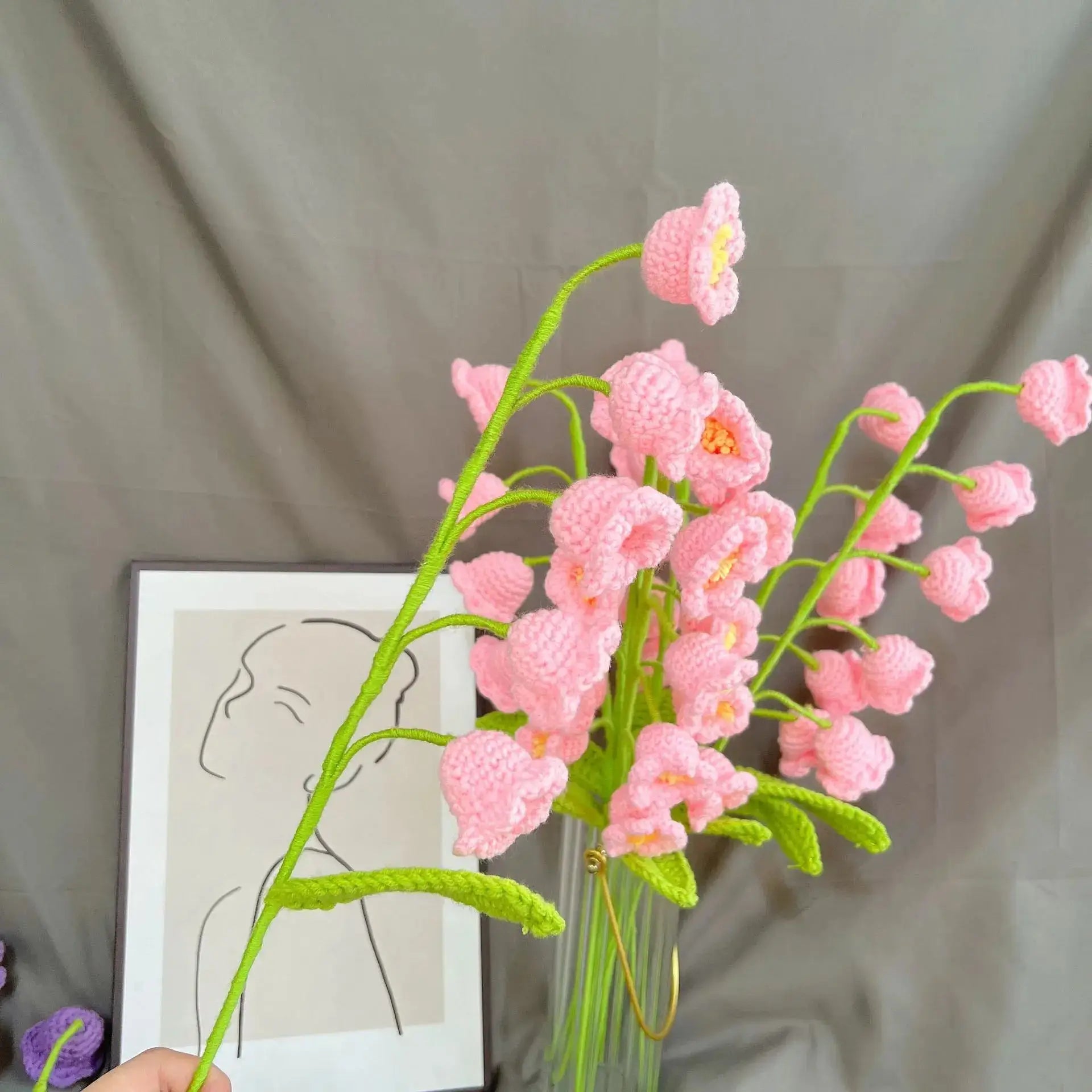 a vase filled with pink flowers next to a picture
