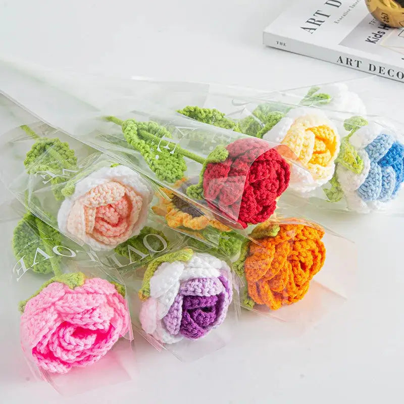a bunch of crocheted flowers sitting on top of a table