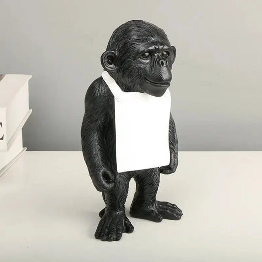 a statue of a monkey holding a piece of paper
