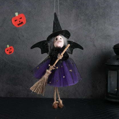 a doll hanging from a string with a broom