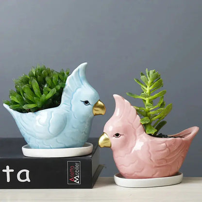 a couple of ceramic birds sitting next to each other
