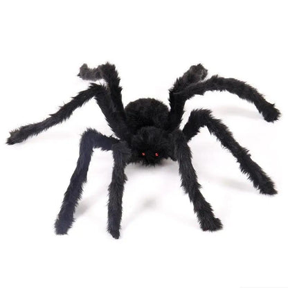 a large black spider sitting on top of a white floor