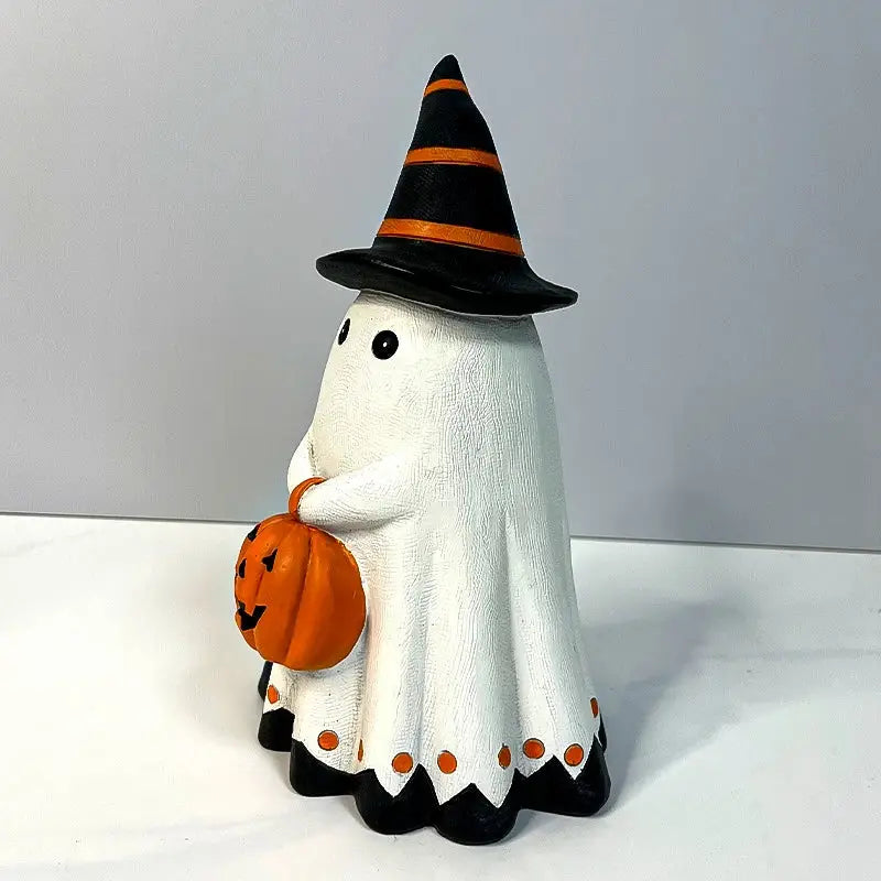 a halloween decoration of a ghost holding a pumpkin