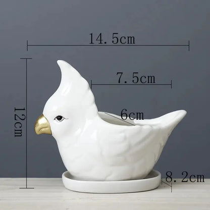a white ceramic bird with a golden beak