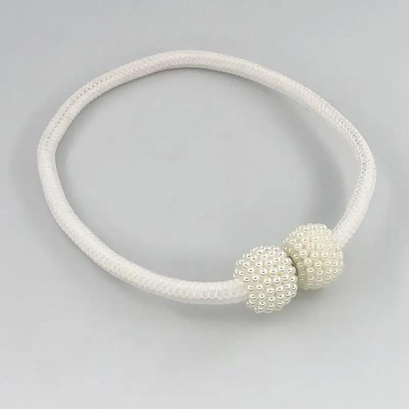 a white bracelet with two beads on a white background