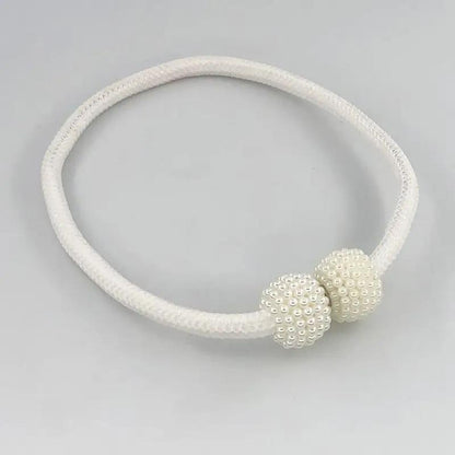 a white bracelet with two beads on a white background