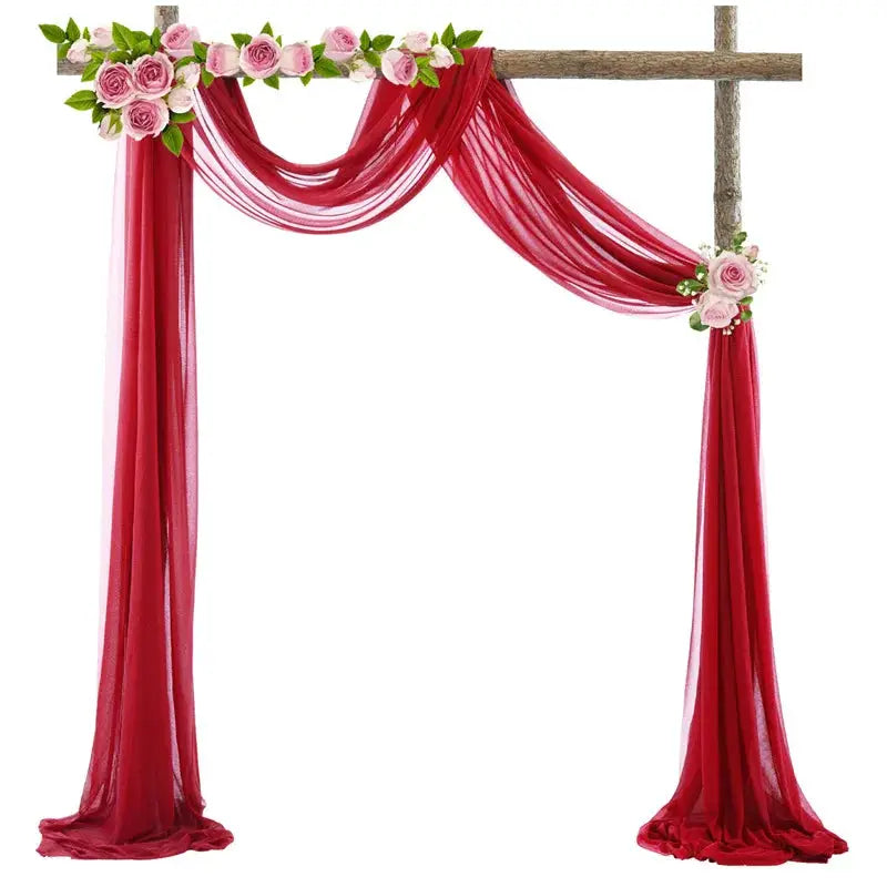 a red wedding arch decorated with flowers