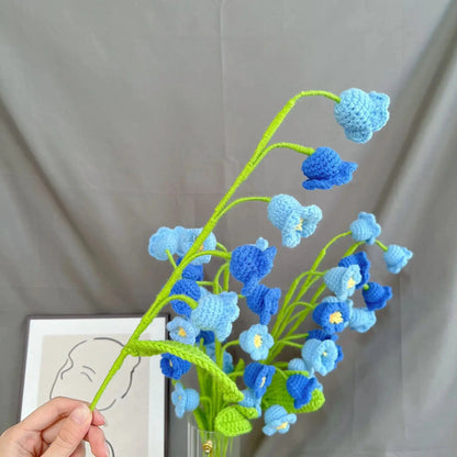 a crocheted blue flower arrangement in a vase