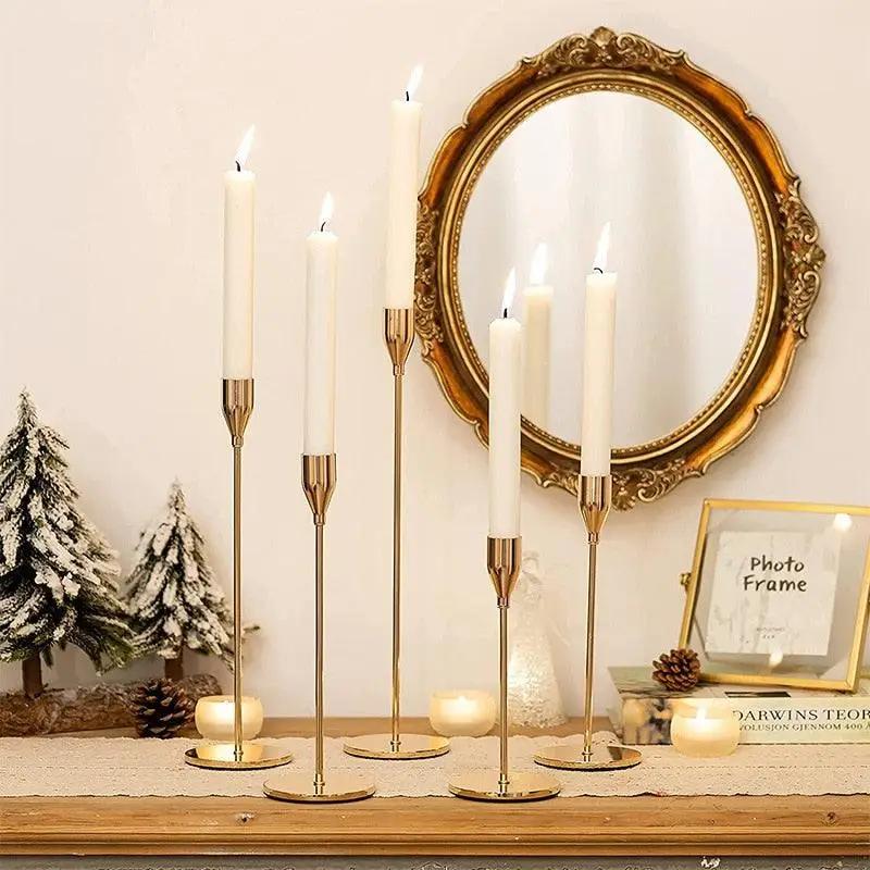 a mantle with candles and a mirror on it