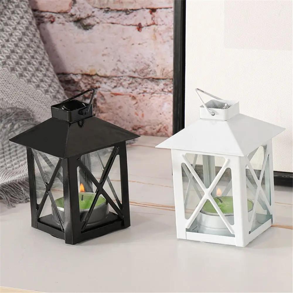 a white and a black lantern on a table