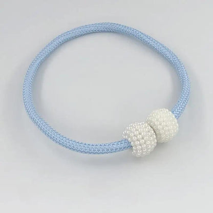 a blue and white bracelet with two beads