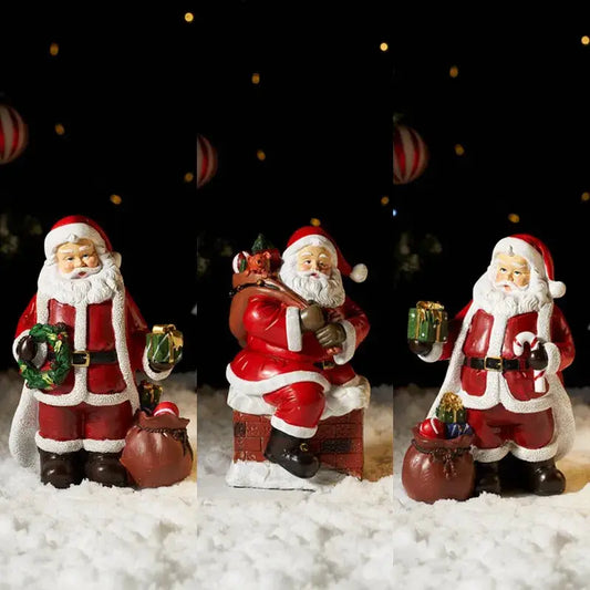 a group of santa clause figurines sitting in the snow
