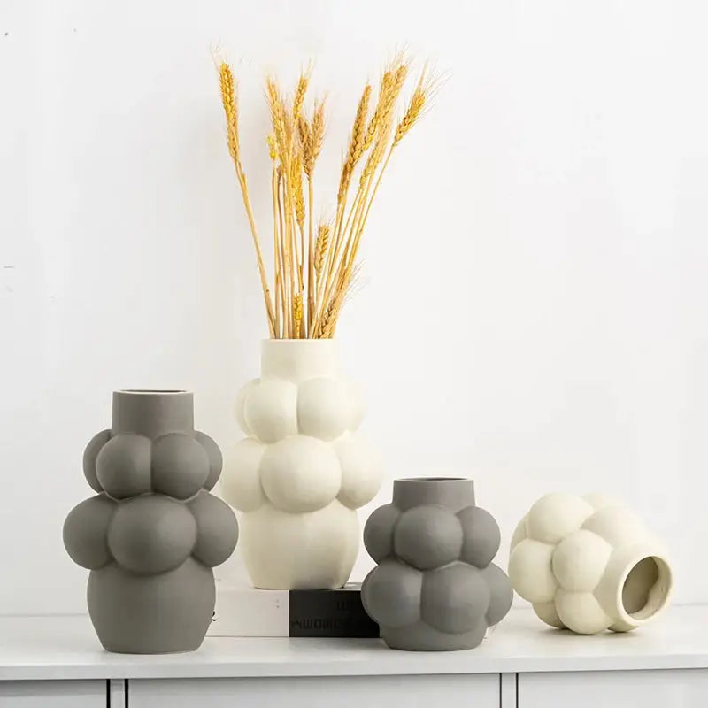 a group of vases sitting on top of a white counter