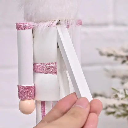 a hand holding a nutcracker made out of paper