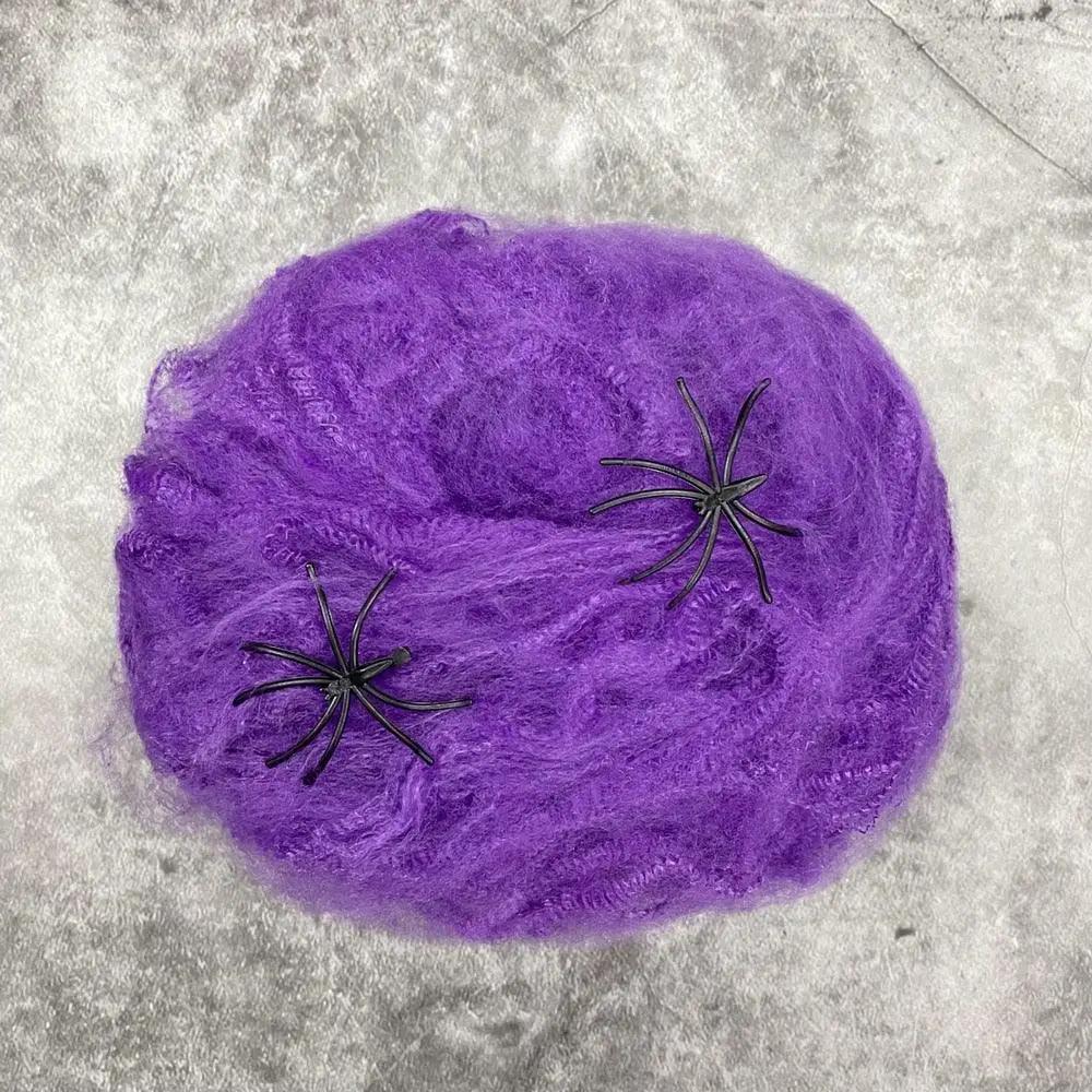 a purple ball of yarn with black spider webs on it
