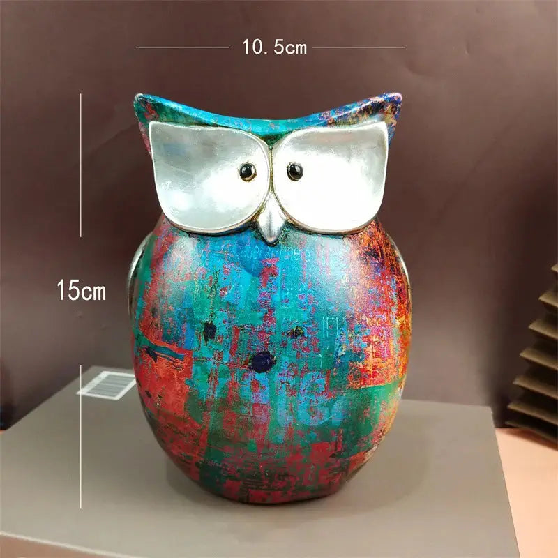 a colorful owl statue sitting on top of a table