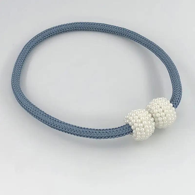 a blue and white bracelet with two white beads