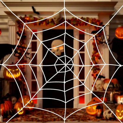 a spider web with pumpkins in the background