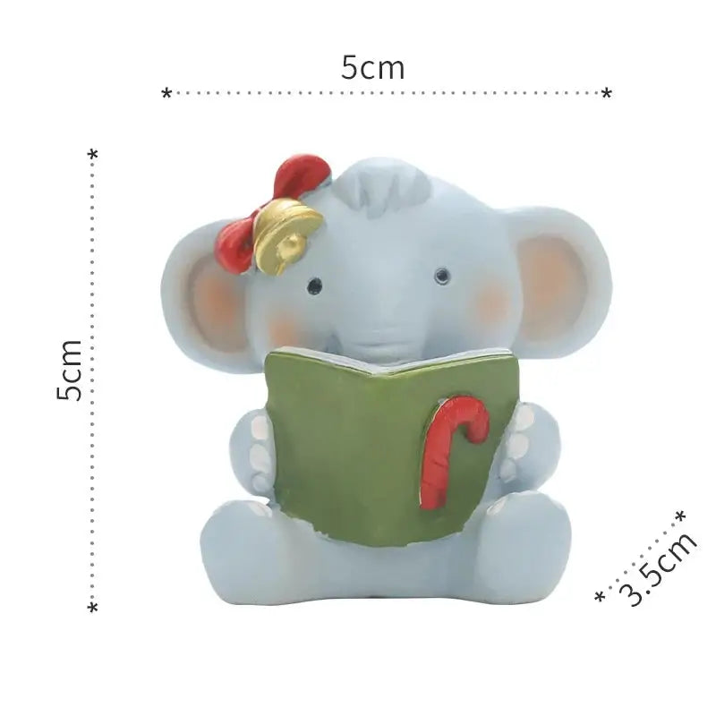 a ceramic elephant reading a book with a bell on its head