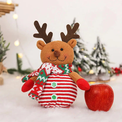 a stuffed animal with a christmas sweater and an apple