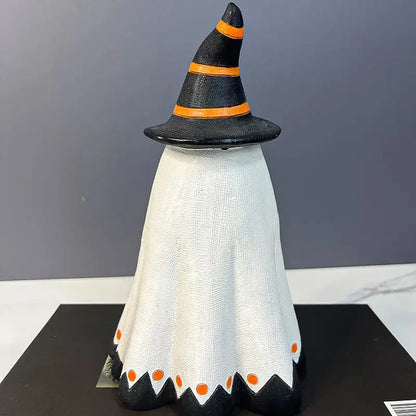 a black and white witch hat with orange dots