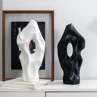 a couple of black and white vases sitting on top of a table