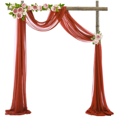 a cross decorated with pink flowers and greenery