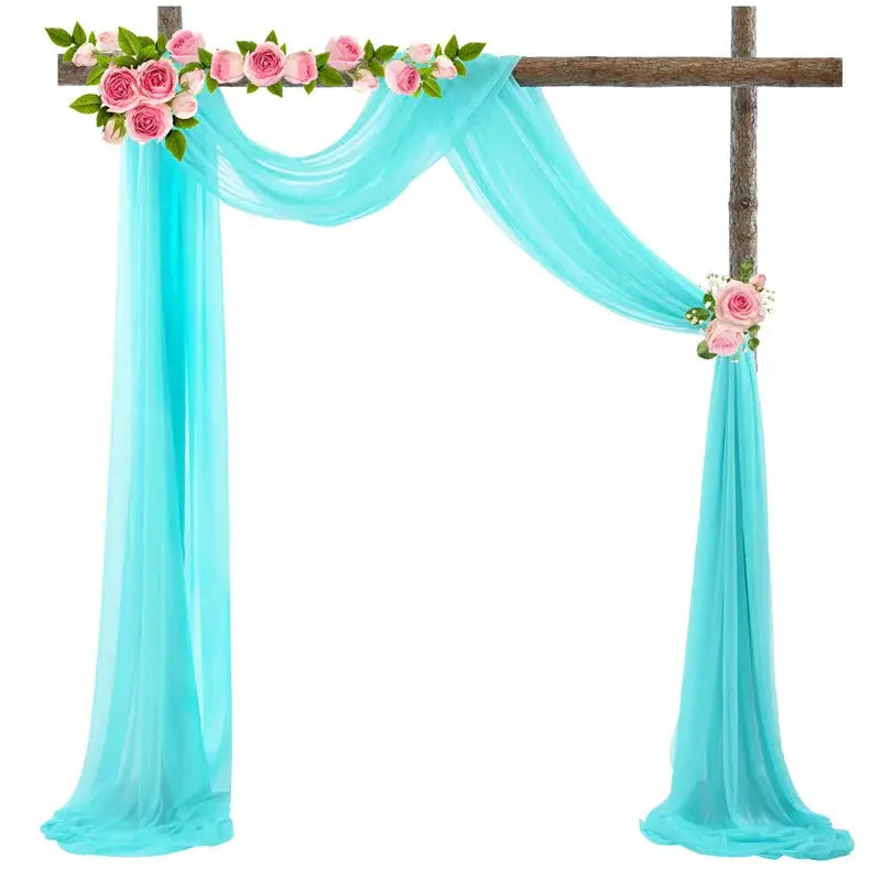 a cross decorated with flowers and a blue drape