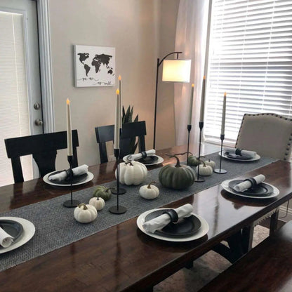 a dining room table is set with black and white dishes