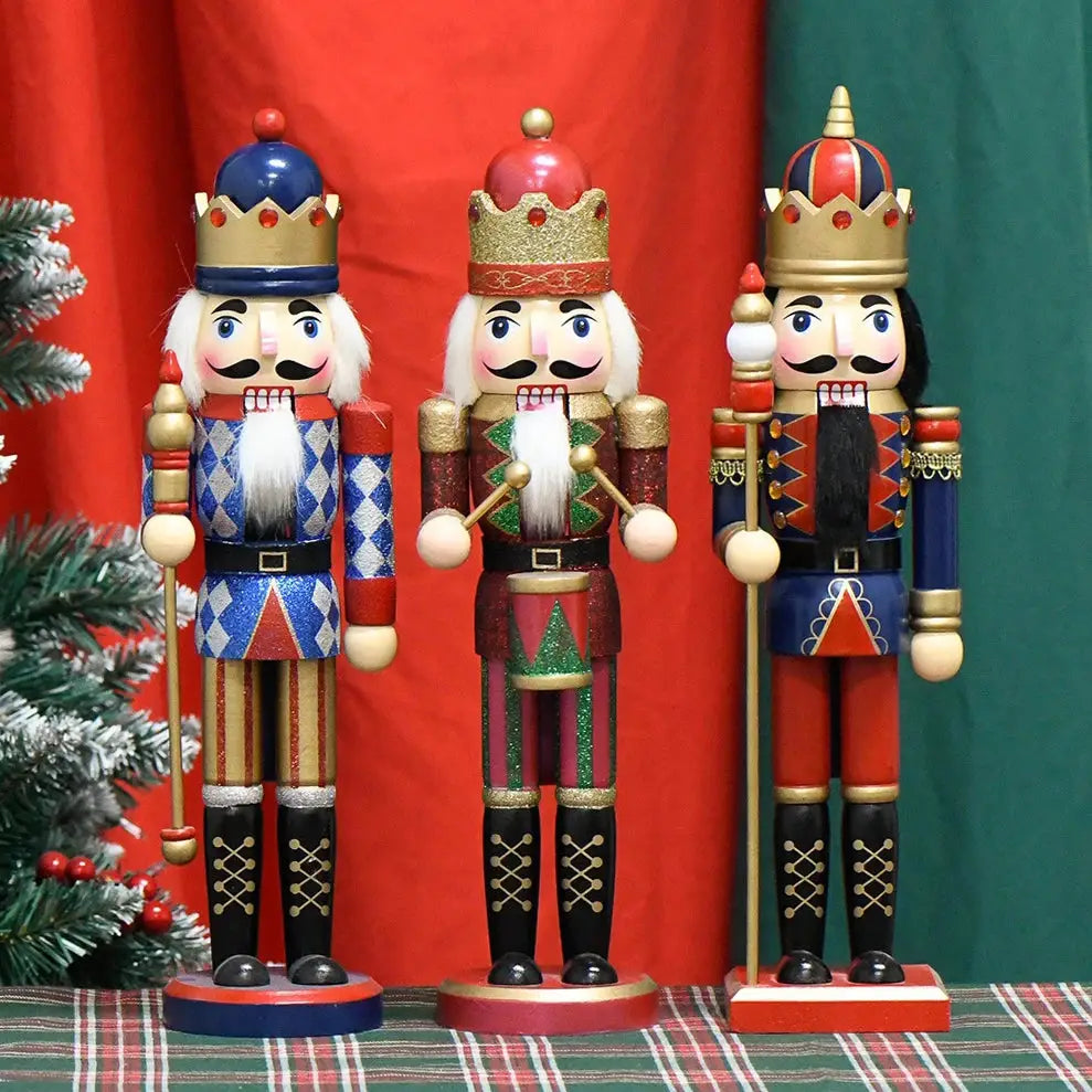 a group of nutcrackers standing next to a christmas tree