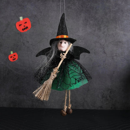 a doll dressed as a witch holding a broom