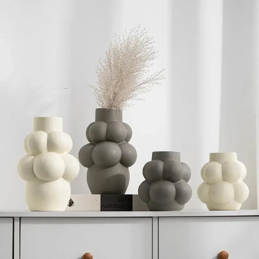 a group of vases sitting on top of a dresser