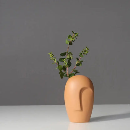 a vase with a plant growing out of it