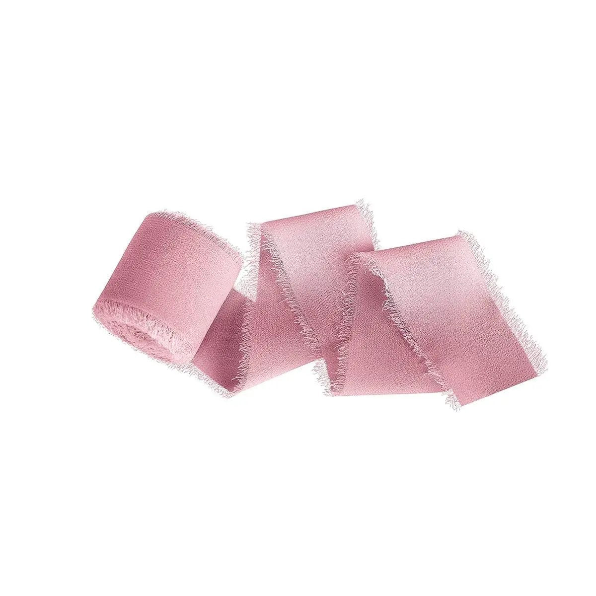three pieces of pink ribbon on a white background