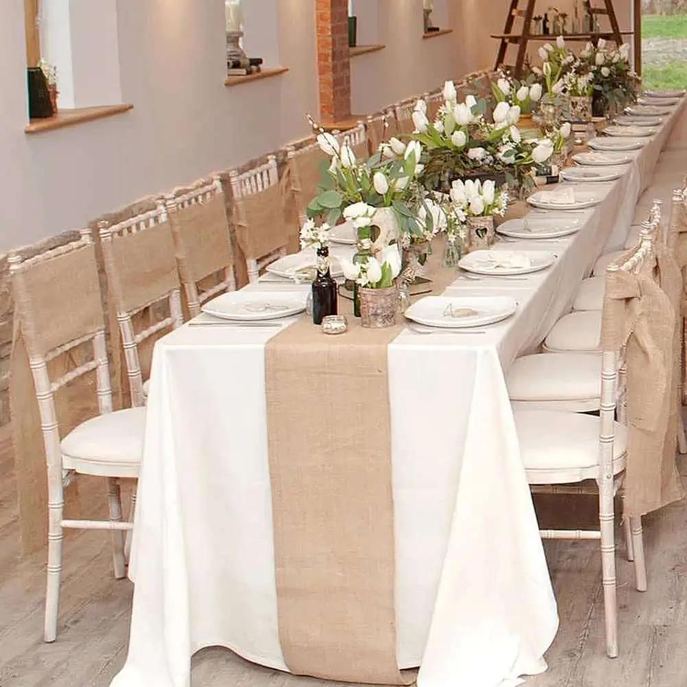 a long table with white flowers and greenery