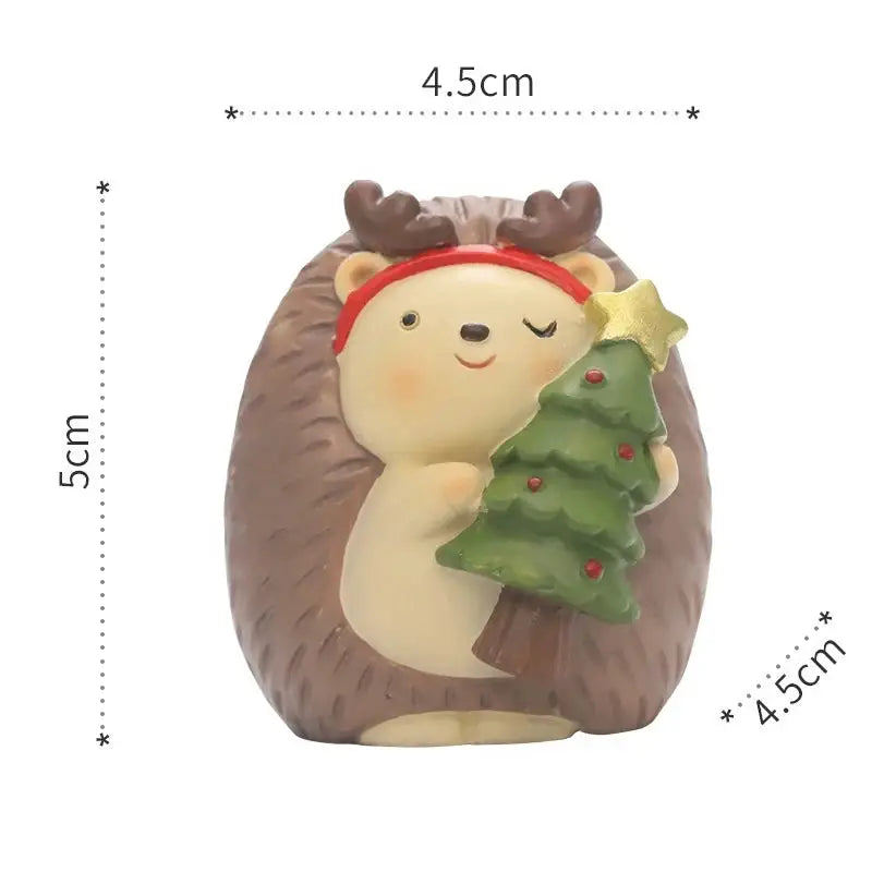 a ceramic figurine of a bear holding a christmas tree