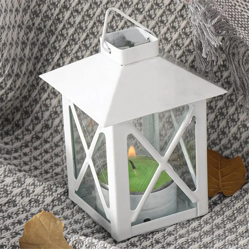 a white lantern with a green candle inside