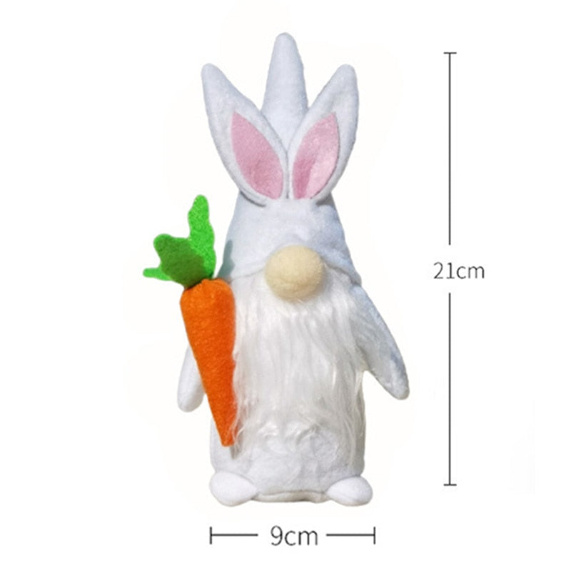 a stuffed rabbit holding a carrot on a white background