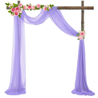 a purple wedding arch decorated with pink flowers