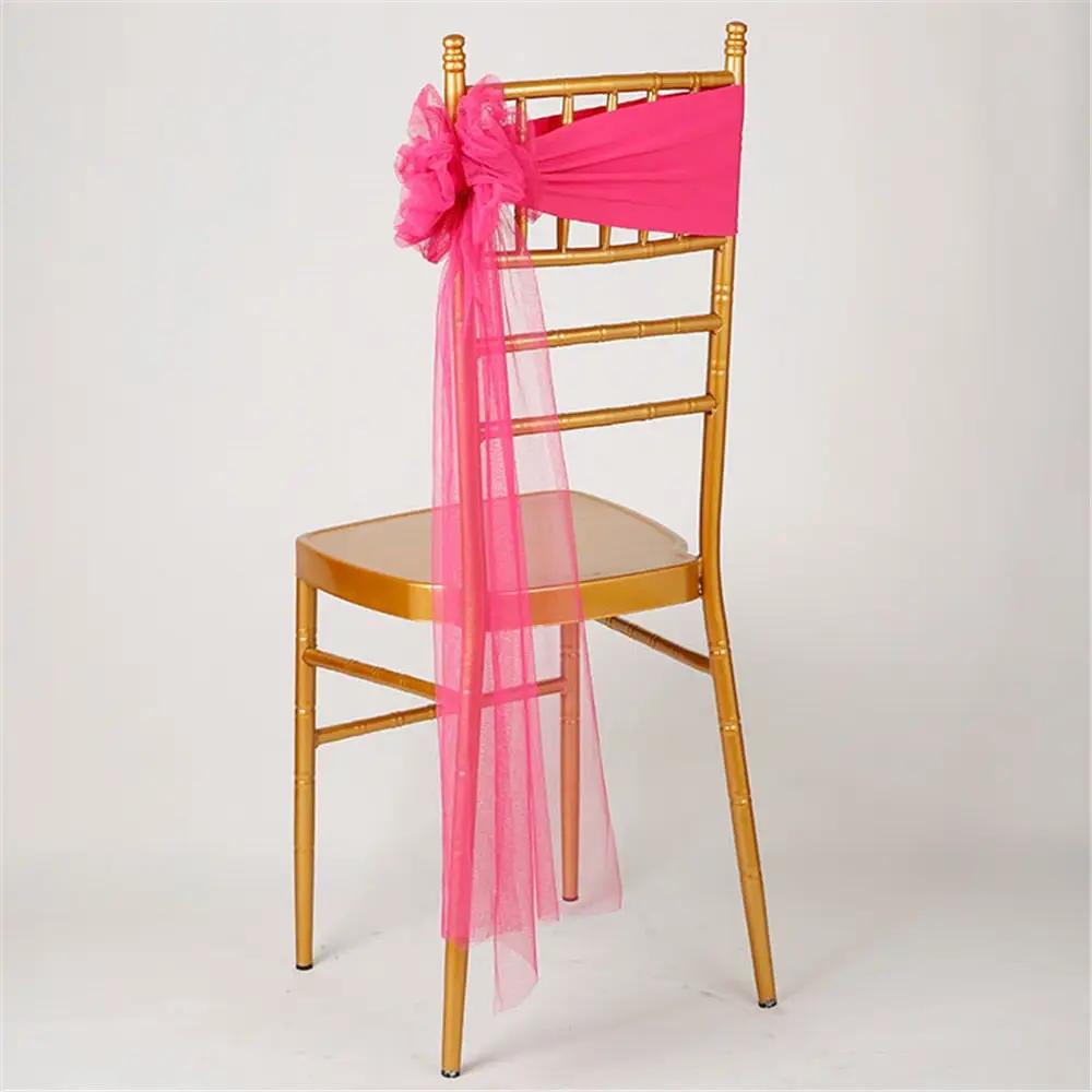 a chair with a pink sash on top of it