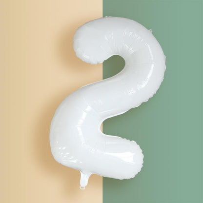 a balloon shaped like the letter s hanging from a wall