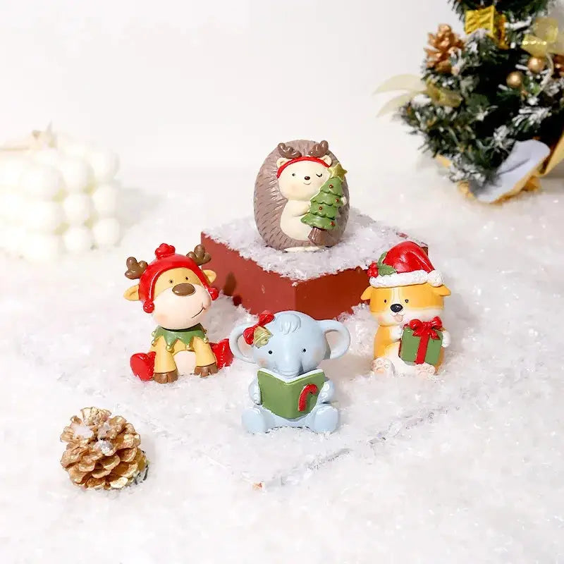 a group of small figurines sitting on top of a pile of snow