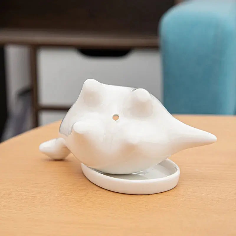 a white elephant figurine sitting on top of a wooden table