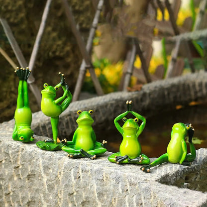 a group of green figurines sitting on top of a stone wall